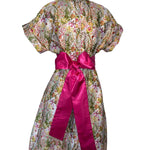 Floral dress with a pink ribbon on a white background