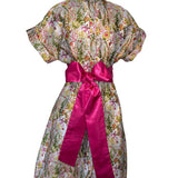 Floral dress with a pink ribbon on a white background